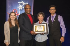 Dr. Sheridan Cyrus receives an award for his contributions to human rights education presented by Nicole Crellin, Youth for Human Rights Toronto Director accompanied by YHR volunteers Kristina Kisin and Abeir Liton. 