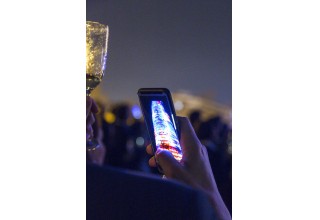 Onlookers Capturing the TravelPerk Logo on Torre Glories