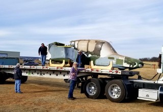 Mike Manclark helps secure the fuselage of an OV-10 Bronco in preparation for its road trip to California for restoration.