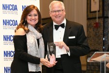 Cindy Padilla, board chair of the National Hispanic Council on Aging (NHCOA), presents the Ophelia Rinaldi Lifetime Achievement Award to John Feather, Ph.D., CEO of Grantmakers In Aging (GIA)