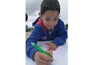 Young boy signs the pledge