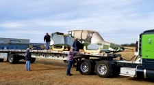 Mike Manclark helps secure the fuselage of an OV-10 Bronco in preparation for its road trip to California for restoration.