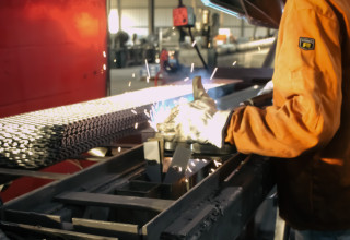 Man Welding Metal Bench Chairs