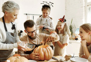 Family Carving Pumpkins Together for Halloween Fun