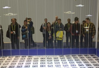 Drones Dance to Music at Trade Show Inside Walk Up Enclosure