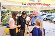 Clean energy practitioners educating guests 