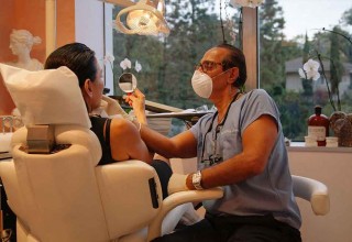 Cosmetic Dentist Dr. Mobasser Examines His Patient