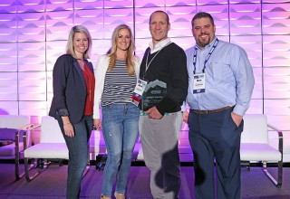 Mick Rodgers and The Axial Benefits Group team accepts the Summit Award 