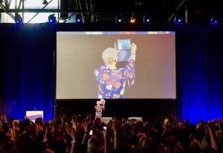 Dr. Brook Bello, takes photo during ovation.