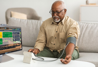 Senior Man Using Addison Care to take blood pressure