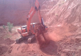 Excavator inside new mining pit