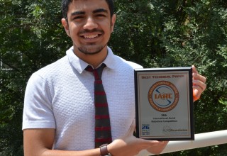Abdullah Almosalami holds the team award