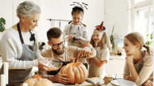 Family Carving Pumpkins Together for Halloween Fun