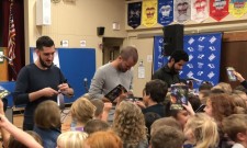 Band members autograph copies of What Are Human Rights? 