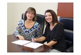 Lynn Fernandez, Chief Credit Officer at Lendistry (right) making it official.
